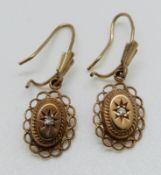 A pair of 9ct gold earrings set with diamonds