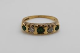 An 18ct gold ring set with emeralds and diamonds (size K)