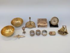 A hallmarked silver hammered cigarette box, filligree items, desk barometer,