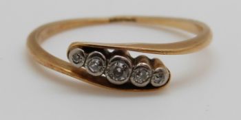 An 18ct gold ring set with five graduated diamonds,