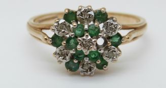 A 9ct gold ring set with emeralds and diamonds in a cluster (size Q)