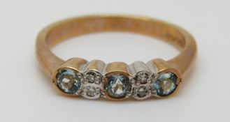 A 9ct gold ring set with blue topaz and diamonds (size M)