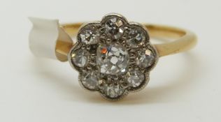 An 18ct gold Victorian ring set with old cut diamonds in a cluster (size M)