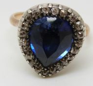 A Victorian ring set with a large pear cut synthetic sapphire of approximately 4.