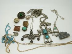 Three Egyptian white metal pendants and chains,