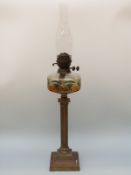 A Victorian cut glass oil lamp with amber and green cut glass reservoir and twin Duplex burner