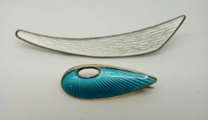 A silver brooch set with white enamel marked Norway and another similar set with blue enamel