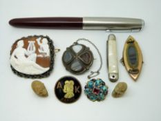 A 9ct gold brooch set with a garnet and two pearls verso a glass compartment,