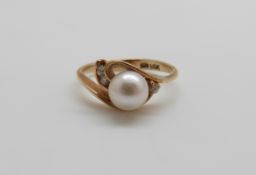 A 14ct gold ring set with a pearl and diamonds, 2.