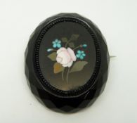 A faceted French jet brooch set with a pietra dura plaque, 4.5 x 3.