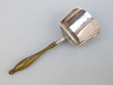 A George III hallmarked silver tea caddy spoon of scoop form with turned stained handle,