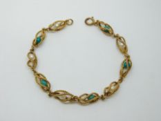 An 18ct gold bracelet made up of cage links with turquoise and pearls
