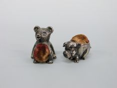 Two white metal novelty pin cushions, one a teddy bear marked sterling silver, height 2.