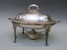 A plated spirit food warmer in the neoclassical style,