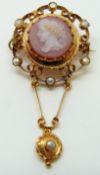 A Victorian gold pendant/ brooch set with a hardstone agate cameo depicting a young woman within a