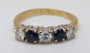 An 18ct gold ring set with alternating sapphires and diamonds, each stone approximately 0.