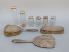 Six various Victorian and later hallmarked topped cut glass dressing table bottles together with a