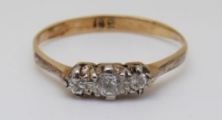 An 18ct gold ring set with three diamonds, 1.