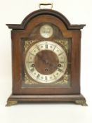 A late 20th century mantel clock in bygone style with silvered Roman chapter ring and cherub mask
