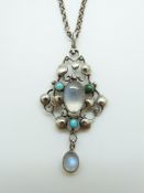 A silver Arts and crafts pendant set with moonstone and turquoise, 4.3 x 2.