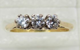 An 18ct gold ring set with three diamonds, totalling approximately 0.45ct, 3.
