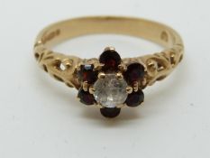 A 9ct gold ring set with garnets and paste