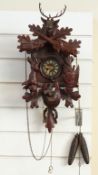 A circa mid 20thC Black Forest carved cuckoo clock in hunting style,