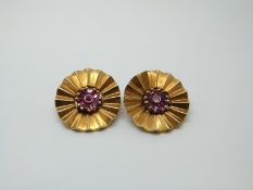 A pair of yellow metal earrings each set with a cluster of rubies to the centre,13.