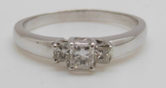 An 18ct gold ring set with three princess cut diamonds totalling approximately 0.