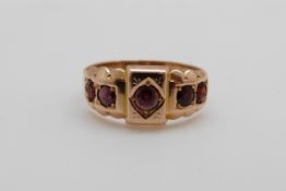 A 15ct gold ring set with five garnets, Chester, 2.