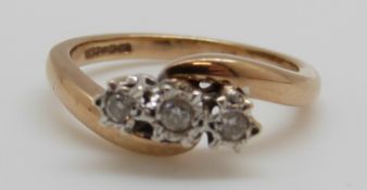 A 9ct gold ring set with three diamonds in a platinum setting, 3.