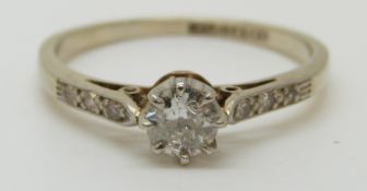 An 18ct gold ring set with a diamond measuring approximately 0.