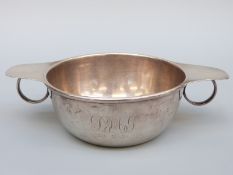 A hallmarked silver porringer with loop handles, Birmingham 1924, maker W.H.Leather, width 16.