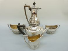 A Victorian and later five piece hallmarked silver tea set with reeded lower body comprising teapot,
