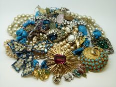 A collection of costume jewellery including an RAF brooch, a Swarovski brooch, bracelet,