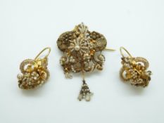 A French filigree gilt floral and foliate brooch set with seed pearls, with matching earrings,