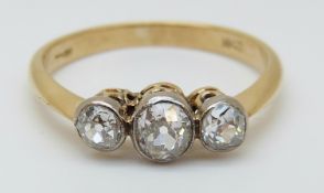 An 18ct gold ring set with three old cut diamonds in a platinum setting,