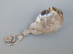 A Victorian hallmarked silver tea caddy spoon with pierced and repoussé floral decoration,