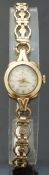 Rolex ladies 9ct gold wristwatch with gold hands and markers and textured face, on pierced bracelet,