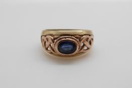 A 9ct gold Clogau ring set with an oval sapphire in a pierced setting (size L/M)