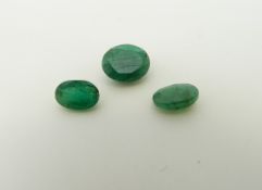 Three oval cut emeralds the largest approximately 1.