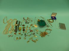 A collection of costume jewellery to include brooches, earrings, watches, faux pearls,