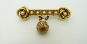 A Victorian brooch in the form of two knots each set with a pearl and a row of pearls between them,
