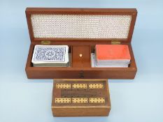 Two inlaid cribbage boards, the largest with cards, both with markers and dice,