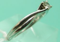 A platinum ring set with a round brilliant cut diamond of approximately 0.2ct by Beaverbrooks, 5.