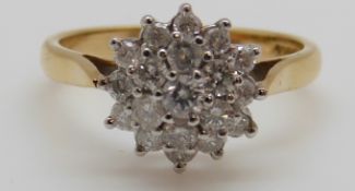 An 18ct gold ring set with diamonds in a cluster, total diamond weight approximately 0.