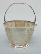 A hallmarked silver pierced bon bon dish or salt in the form of a basket with swing handle with