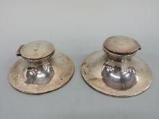 Two early 20thC hallmarked silver capstan inkwells, diameters 11.