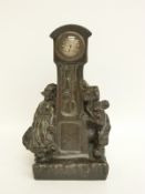 A late 19thC bronze clock/model in the form of a longcased clock and two figures of Dutch children,