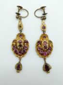 A pair of Victorian pinchbeck repoussé earrings set with pink paste and seed pearls
